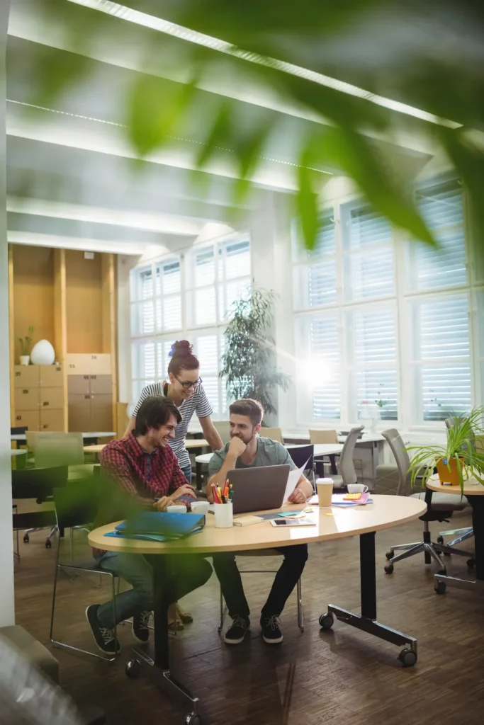 Team working together at a shared table in a Nexus office